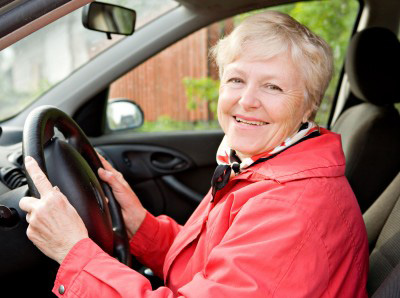 Smiling Florida senior driver in car